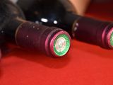 several bottles of wine are lined up on a red table