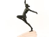 statue of a woman holding a spear on a wooden base