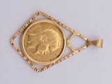an image of a gold plated pendant with an elephant on it