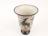 a black and white vase with a picture of a deer on it