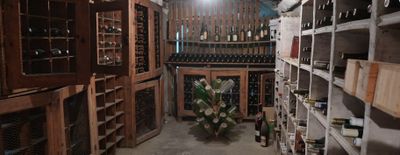 many bottles of wine sitting on shelves in a wine cellar