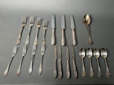 many forks and spoons laid out on a table