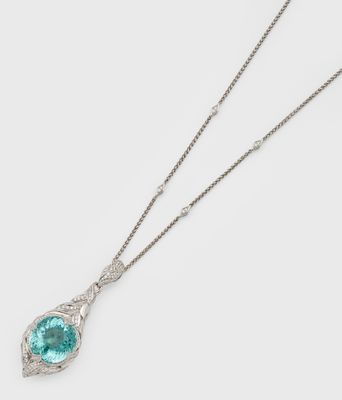 a necklace with a blue topaz stone on a chain