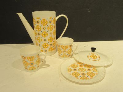 a white table with yellow and blue flowers on it