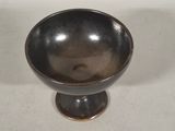 a black bowl sitting on top of a white table