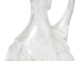 a clear glass pitcher that is sitting on a table