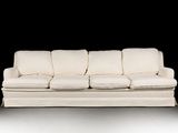 a white couch that is sitting on a white floor