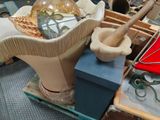a large vase with a wooden stick in it sitting on a table