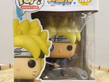 a close up of a pop vinyl figure in a box on a table