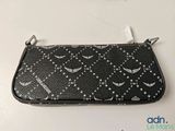 black leather purse with white stars and crescents on it