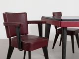 two chairs and a table with a glass top