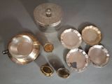 a lot of silver dishes and cups on the table
