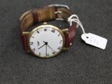 a watch that is sitting on a table with a price tag attached to it