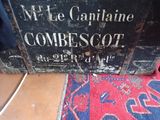 an old wooden box that has a sign on it