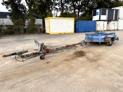 a trailer with a trailer attached to it in a parking lot