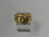 a close up of a gold ring on a white surface