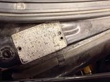 a close up of a car ' s engine with a tag attached to it