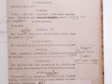 un livre ouvert avec une écriture manuscrite posé sur une table