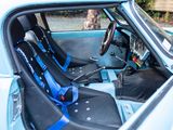 a blue car with two seats and a steering wheel