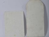 two pieces of paper on a white surface next to each other