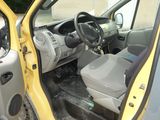 a small yellow car with the door open and the driver ' s seat down
