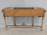 a wooden table with a marble top and gold legs