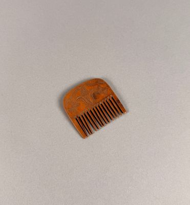 a wooden comb that is sitting on a table