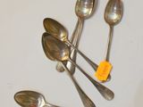 five spoons and a spoon with a tag on them