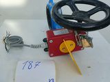 a red valve on a white table with a sign on it
