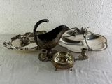 a silver plate and a silver bowl on a table