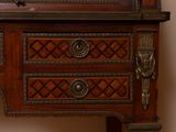 a wooden cabinet with a mirror on top of it