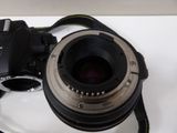 a camera with a lens attached to it on a table