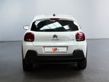 the rear end of a white citrole parked in a room
