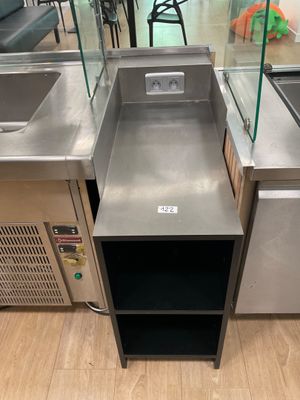 stainless steel sink and counter in a store with chairs in the background