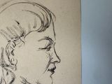 a drawing of a woman ' s face on a piece of paper