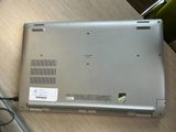 a laptop that is sitting on a table with a charger
