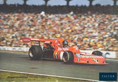 a man driving a race car on a track