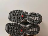 the soles of a pair of running shoes on top of a cardboard box