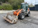 a tractor that is parked in a parking lot