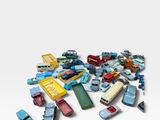 a pile of toy cars on a white surface