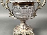 an antique silver plated bowl with ornate handles and a lid