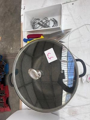 a pan sitting on top of a table next to other items
