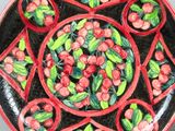 a red plate with flowers on it sitting on a table