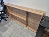 an image of a desk with a bookcase and a chair