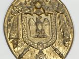 an image of a gold medal with a coat of arms on it