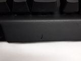 a close up of a black keyboard on a white surface