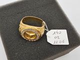a gold ring with a diamond on top of a black box