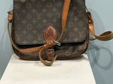 louis vuitton crossbody bag on display in a museum