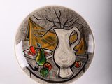 a plate with a painting of a pitcher and fruit on it