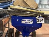 a blue cart with a box on top of it in a store